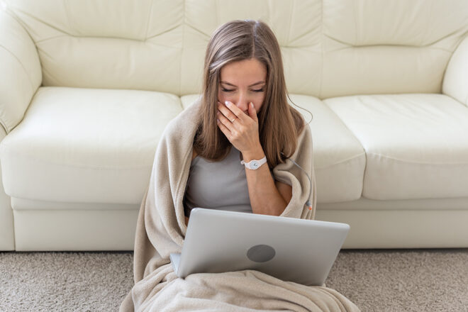 Close Up portrait of unhealthy young European blonde woman coughing a lot, suffering with cough, has a chest pain
